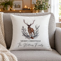 White cushion on a grey sofa, stag and foliage wreath, 