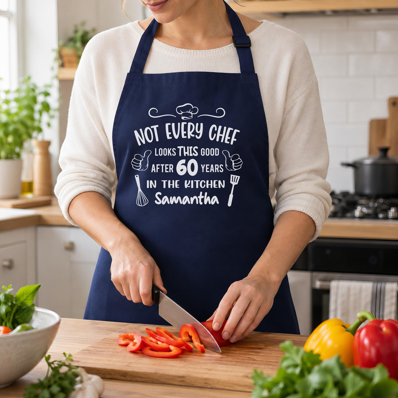 Navy apron with 'NOT EVERY CHEF' 60 years 'Samantha' print, woman slicing red peppers - personalised apron