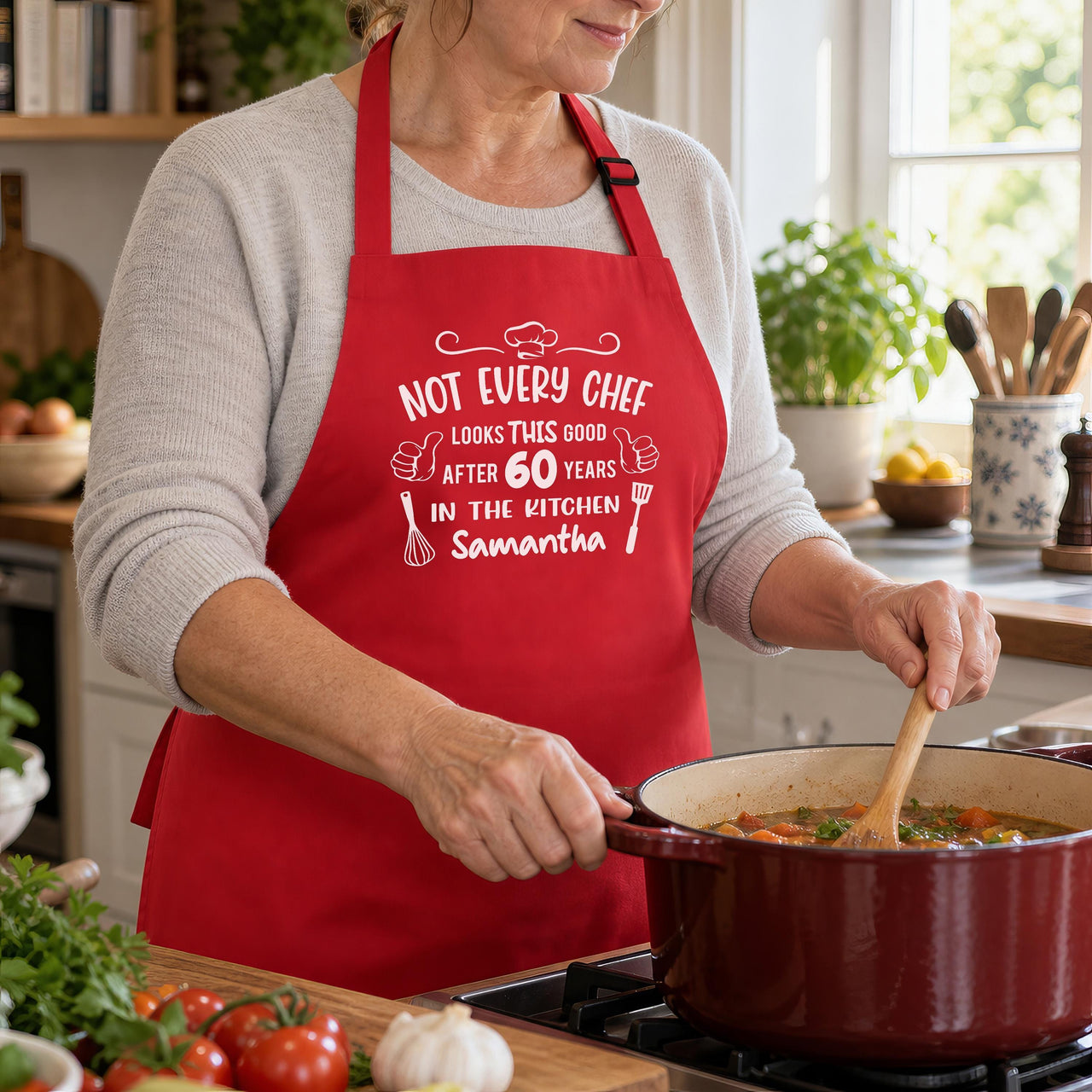 Red apron with white 'NOT EVERY CHEF' 60 years 'Samantha' print, stirring stew on the hob - personalised apron