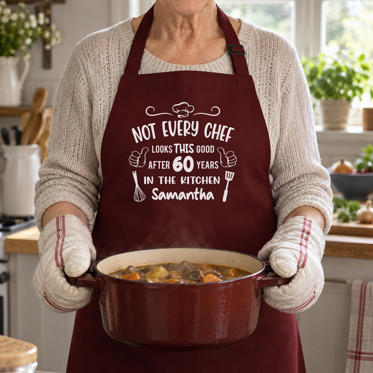 Burgundy apron printed 'NOT EVERY CHEF' 60 years 'Samantha', carrying a pot of stew - personalised apron