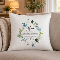 White cushion with 'Mum' and 'IT'S HARD TO FIND THE WORDS' verse in green leaves on a sofa - personalised cushion
