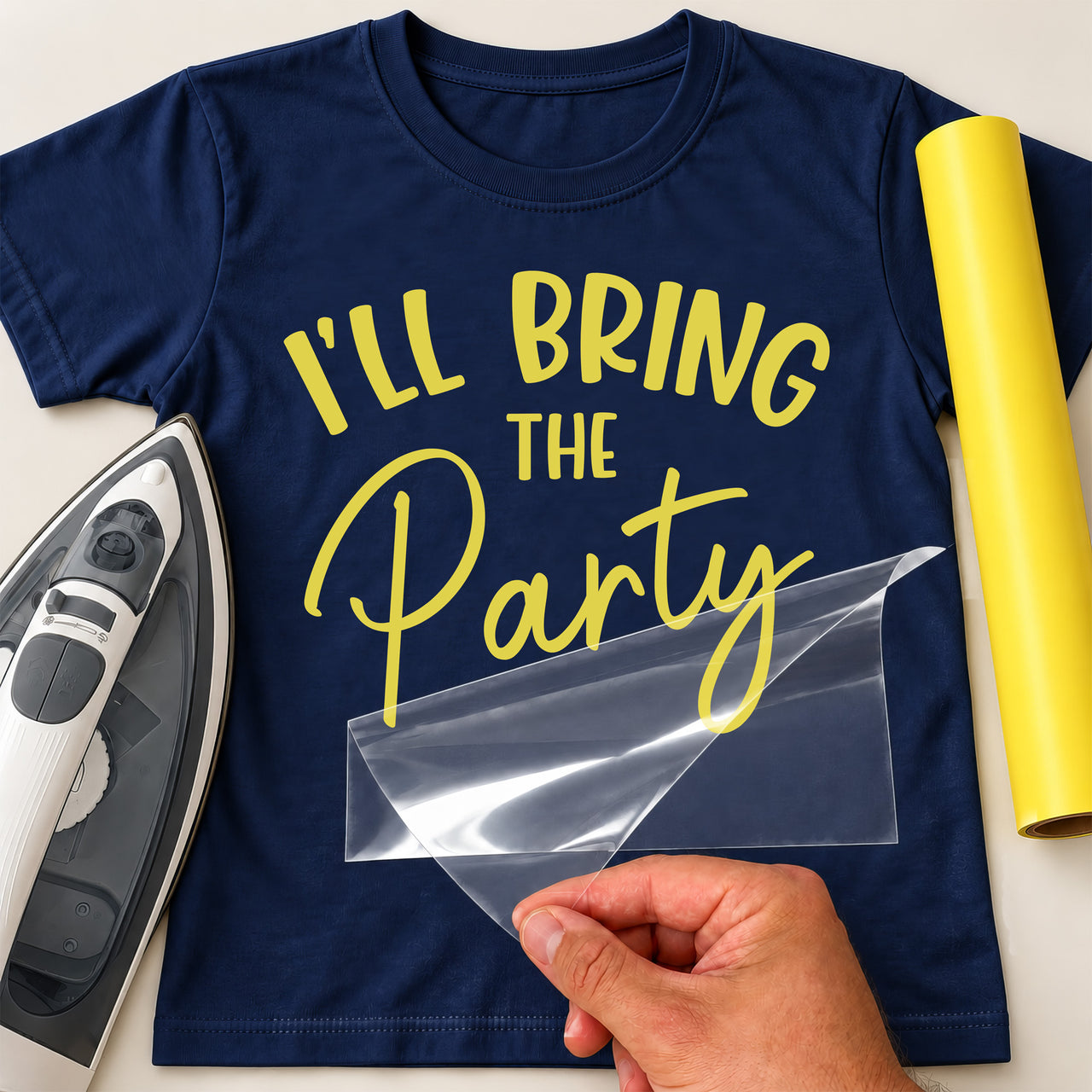 Navy T-shirt with yellow vinyl 'I'LL BRING THE Party', iron-on vinyl transfer being peeled