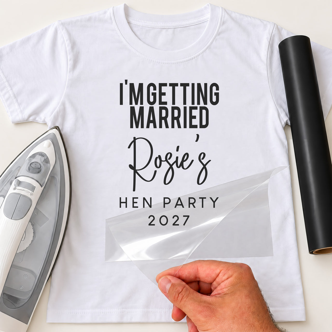 Mockup: white tee with black vinyl 'I'm getting married', script name 'Rosie's', 'Hen party 2027'