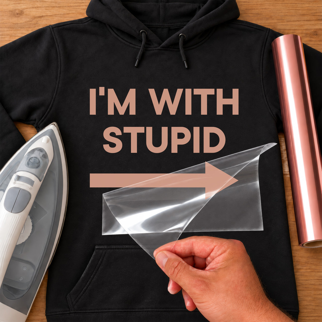 Black hoodie with 'I'M WITH STUPID' and a right arrow in rose gold vinyl, iron-on vinyl transfer