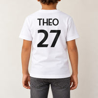 Kids Sports Kit Name Number Iron-On Transfer, shown on a white kids t-shirt (back view)