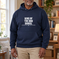 King Of The BBQ Personalised Iron-On Transfer, shown on a navy hoodie