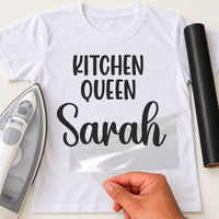 White tee mockup with black vinyl 'KITCHEN QUEEN' and the name 'Sarah' in script, film peeled back