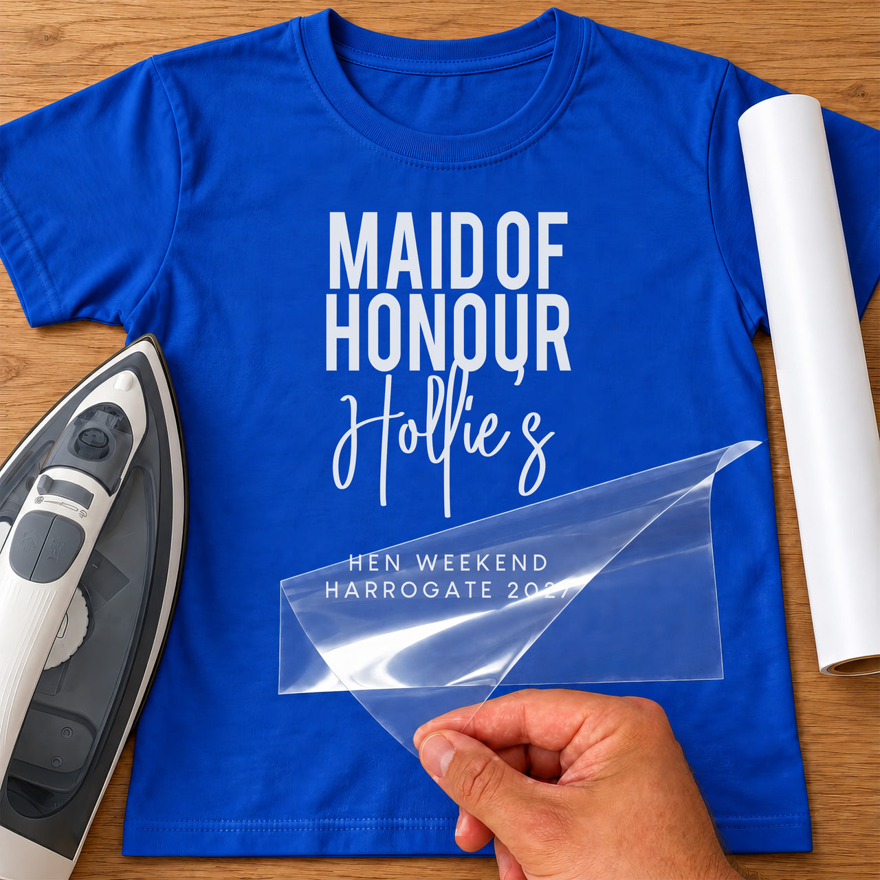 Blue T-shirt mockup with white vinyl 'Maid of Honour', script 'Hollie's' and 'Hen Weekend Harrogate'