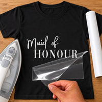 Black T-shirt with white vinyl 'Maid of HONOUR' in script and serif capitals, iron-on vinyl transfer being peeled
