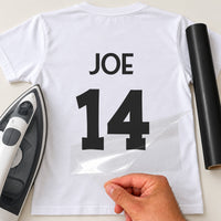 Martial Arts Gi Name Number iron-on transfer: black JOE 14 on a white T-shirt, film being peeled