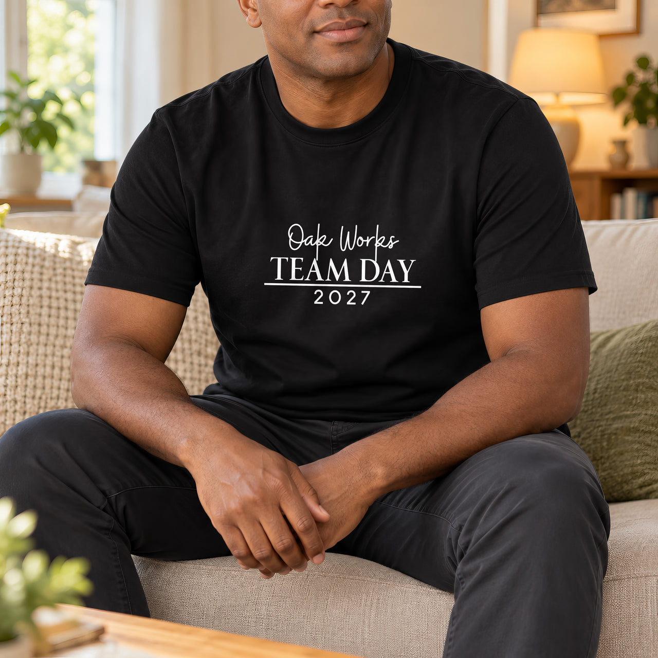 Iron On Corporate Text, shown on a black t-shirt