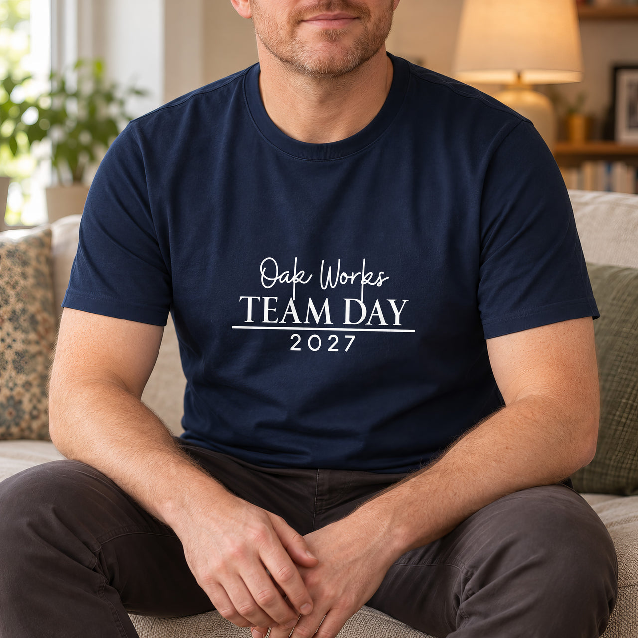 Iron On Corporate Text, shown on a navy t-shirt