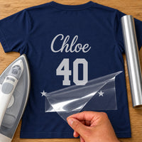 Milestone Birthday Number iron-on transfer: silver Chloe 40 with stars on a navy T-shirt, film being peeled