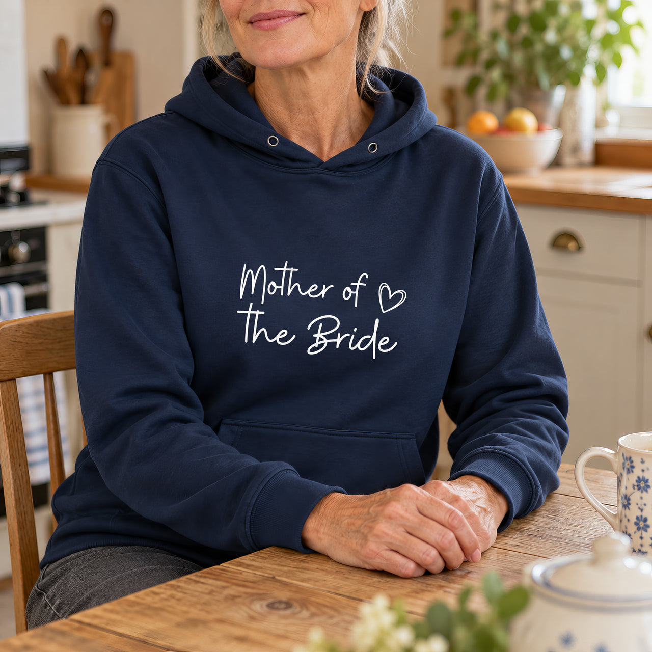 Navy hoodie with the Mother of the Bride Heart Script design printed on the chest