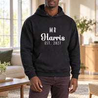 Mr Surname Est. Iron-On Transfer - Personalised Wedding Couple Design, shown on a black hoodie