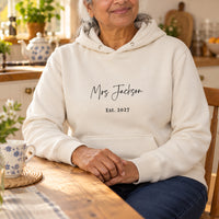 Mrs Surname Iron-On Transfer - Personalised Wedding Established Year Design, shown on a natural hoodie
