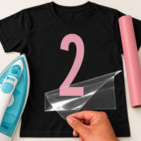 Black T-shirt with a large pink number '2' iron-on transfer, iron and pink vinyl roll for a second birthday