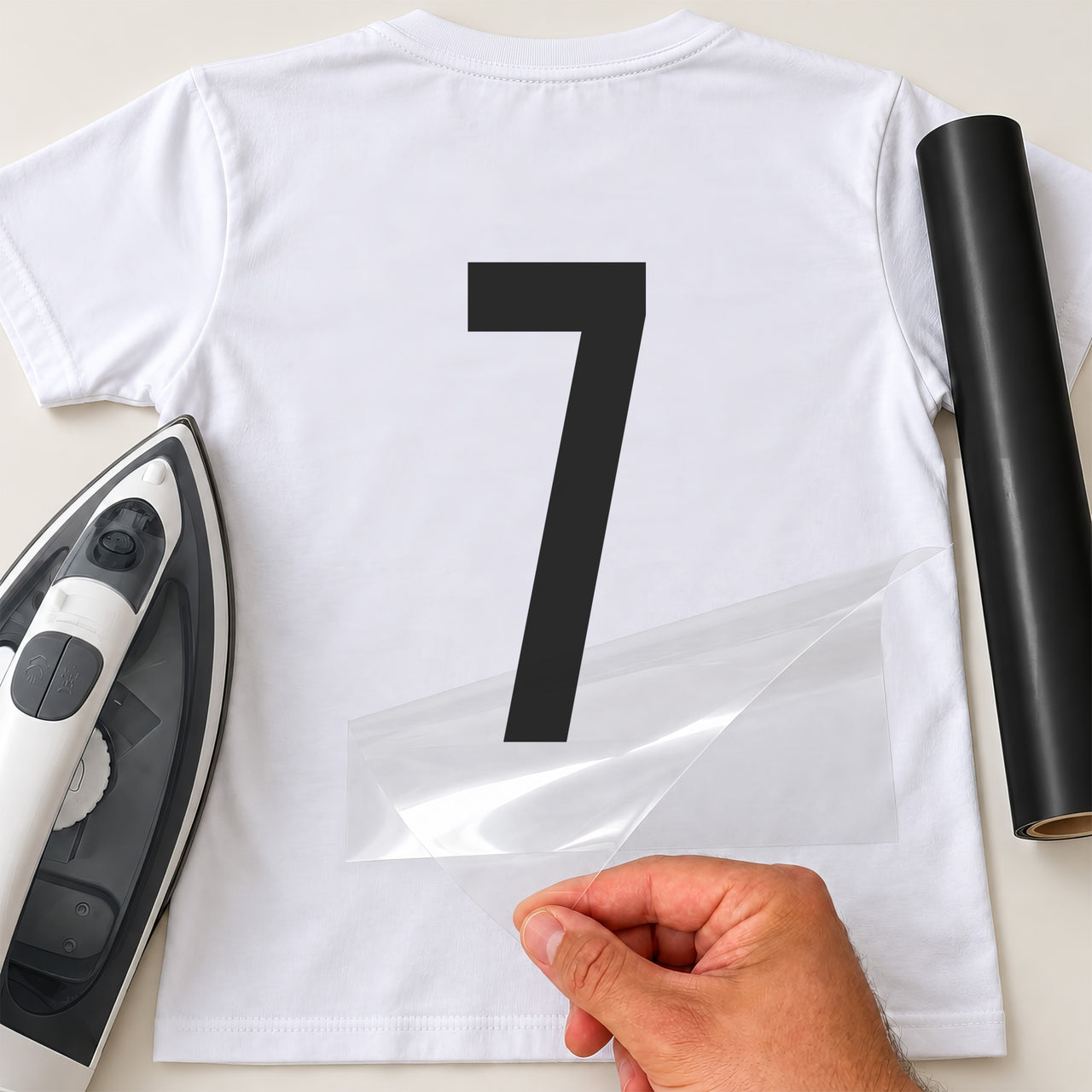 Number Day Digits iron-on transfer: black number 7 on a white T-shirt, film being peeled
