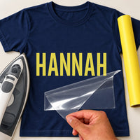 Personalised Beautician Name iron-on transfer: yellow HANNAH on a navy T-shirt, film being peeled