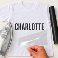Personalised Car Valeter Name iron-on transfer: black CHARLOTTE on a white T-shirt, film being peeled