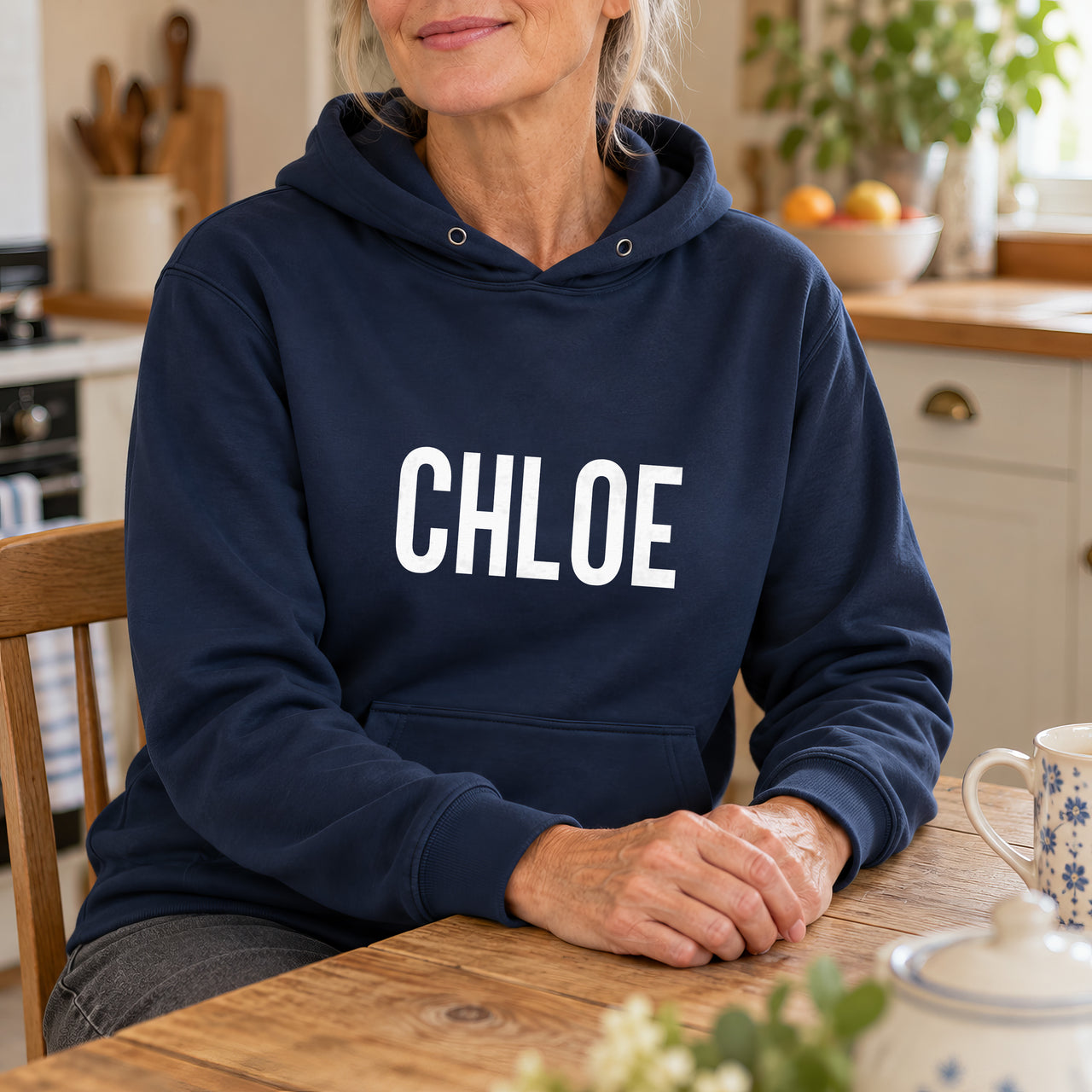 Personalised Carer Team Name Iron-On Transfer, shown on a navy hoodie