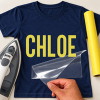 Personalised Carpenter Name iron-on transfer: yellow CHLOE on a navy T-shirt, film being peeled
