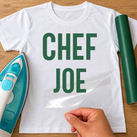 Personalised Chef iron-on transfer: green CHEF JOE on a white T-shirt, film being peeled