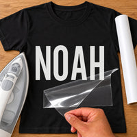 Handyman Name iron-on transfer: white NOAH on a black T-shirt, film being peeled