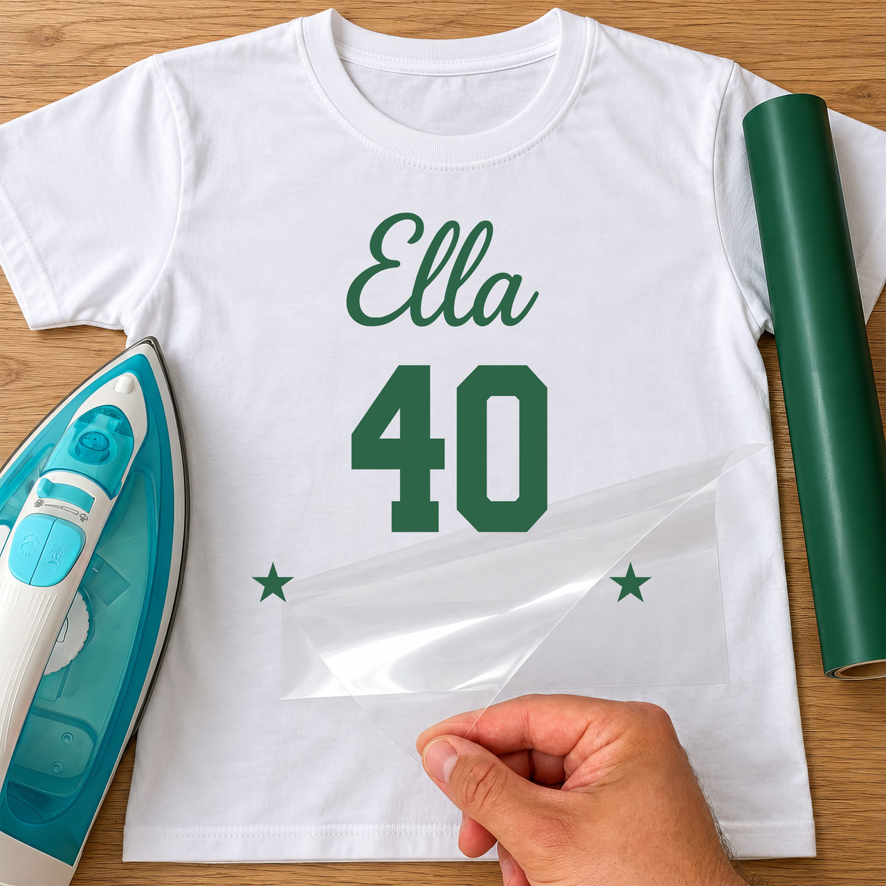 White T-shirt with green 'Ella' script, '40' and two stars iron-on transfer, iron and green vinyl roll