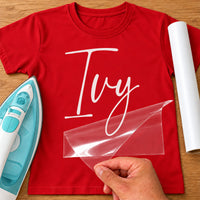 Pony Mad Name iron-on transfer: white script Ivy on a red T-shirt, film being peeled