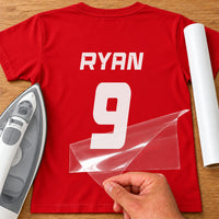 Rugby Shirt Name Number iron-on transfer: white RYAN 9 on a red T-shirt, film being peeled