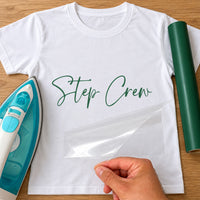 Street Dance Crew iron-on transfer: green script Step Crew on a white T-shirt, film being peeled