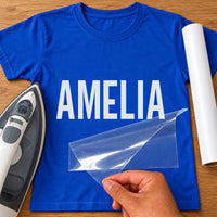 Student Nurse Name iron-on transfer: white AMELIA on a royal blue T-shirt, film being peeled