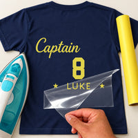 Pub Golf Captain & Number iron-on transfer: yellow Captain 8 LUKE on a navy T-shirt, film being peeled