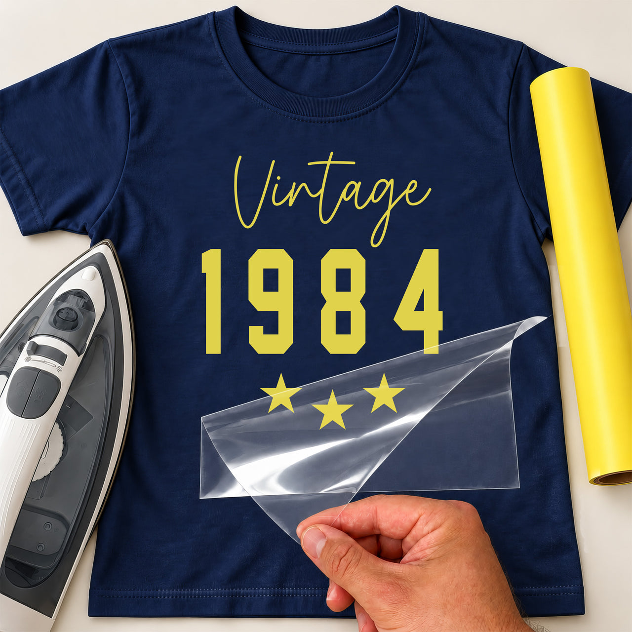 Navy T-shirt with yellow 'Vintage 1984' and three stars, birthday iron-on transfer with film peeled back