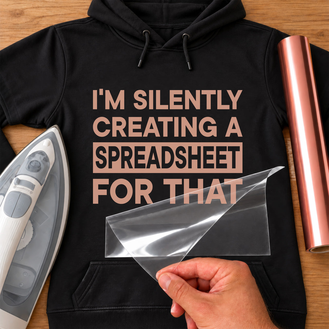 Black hoodie mockup with rose gold "I'M SILENTLY CREATING A SPREADSHEET FOR THAT" slogan
