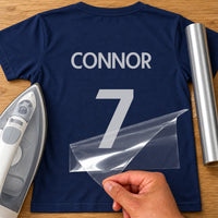 Sunday League Shirt Name Number iron-on transfer: silver CONNOR 7 on a navy T-shirt, film being peeled
