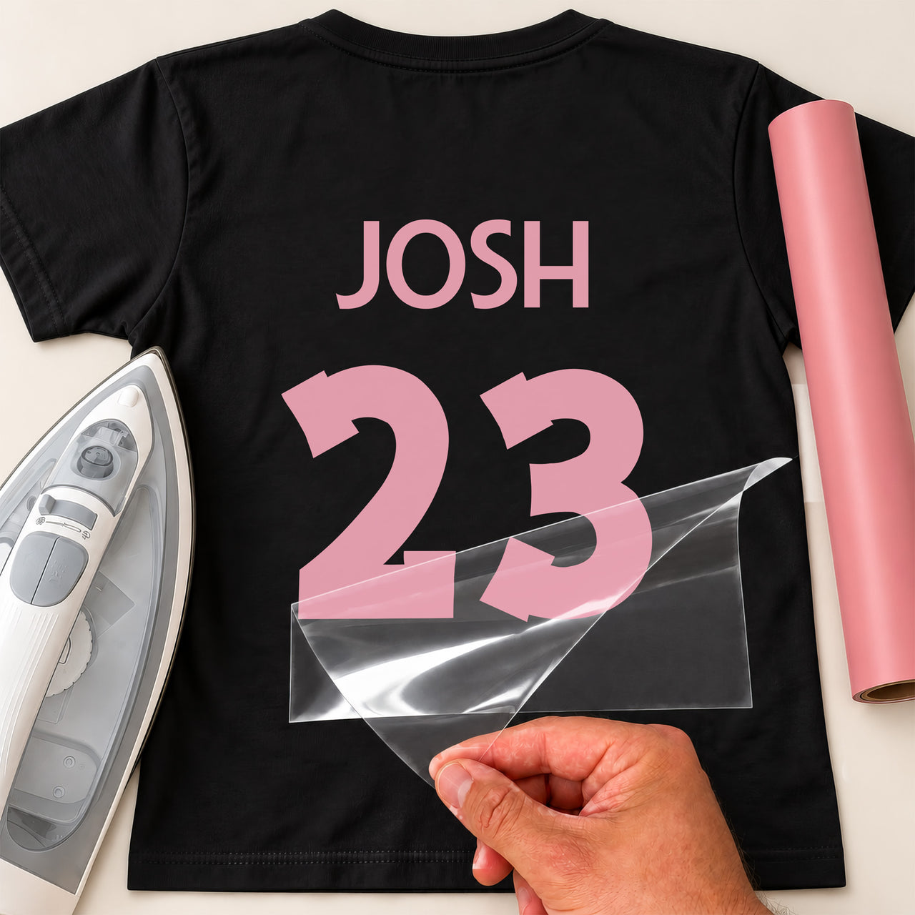 Table Tennis Shirt Name Number iron-on transfer: pink JOSH 23 on a black T-shirt, film being peeled