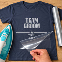 Navy T-shirt with grey 'TEAM GROOM' iron-on transfer, star divider and 'YORK 2027', iron and silver vinyl roll