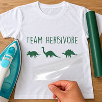 White T-shirt mockup with green 'Team Herbivore' iron-on vinyl and three plant-eating dinosaur silhouettes