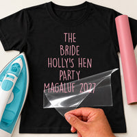 Mockup: black tee with pink vinyl hen party wording 'The Bride', 'Holly's hen party Magaluf 2027'