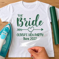 White tee mockup with green 'THE Bride', arrow with heart, 'OLIVIA`S HEN PARTY Ibiza 2027', carrier sheet peeled back