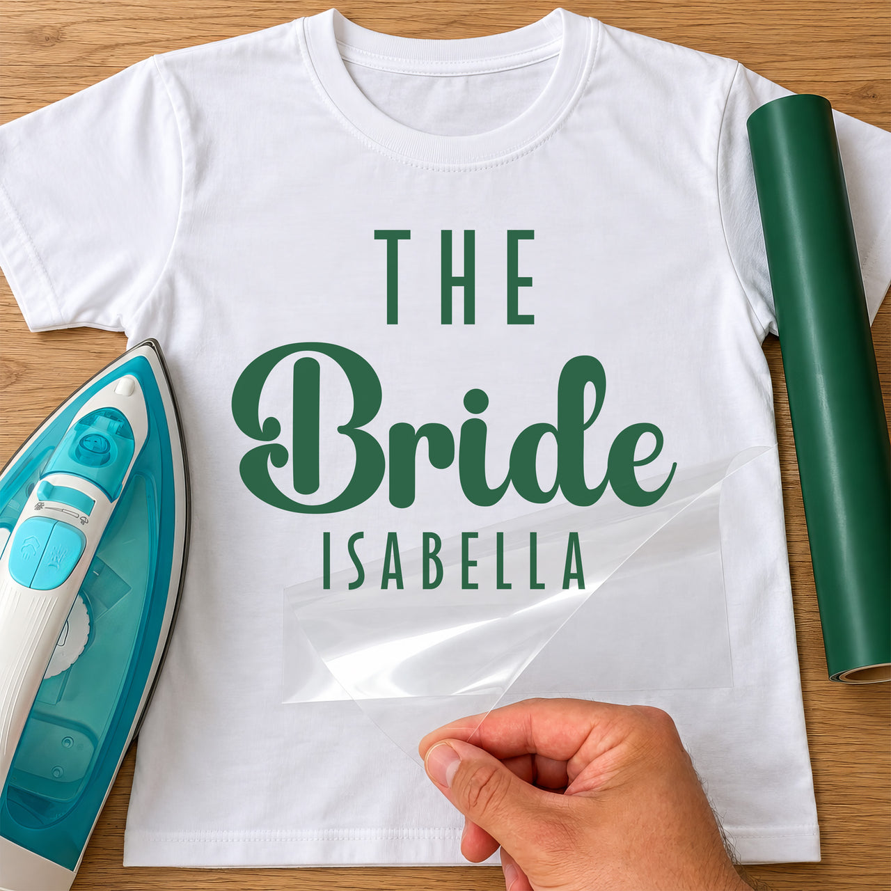 White T-shirt with green 'THE Bride ISABELLA', personalised bride iron-on transfer next to a green vinyl roll