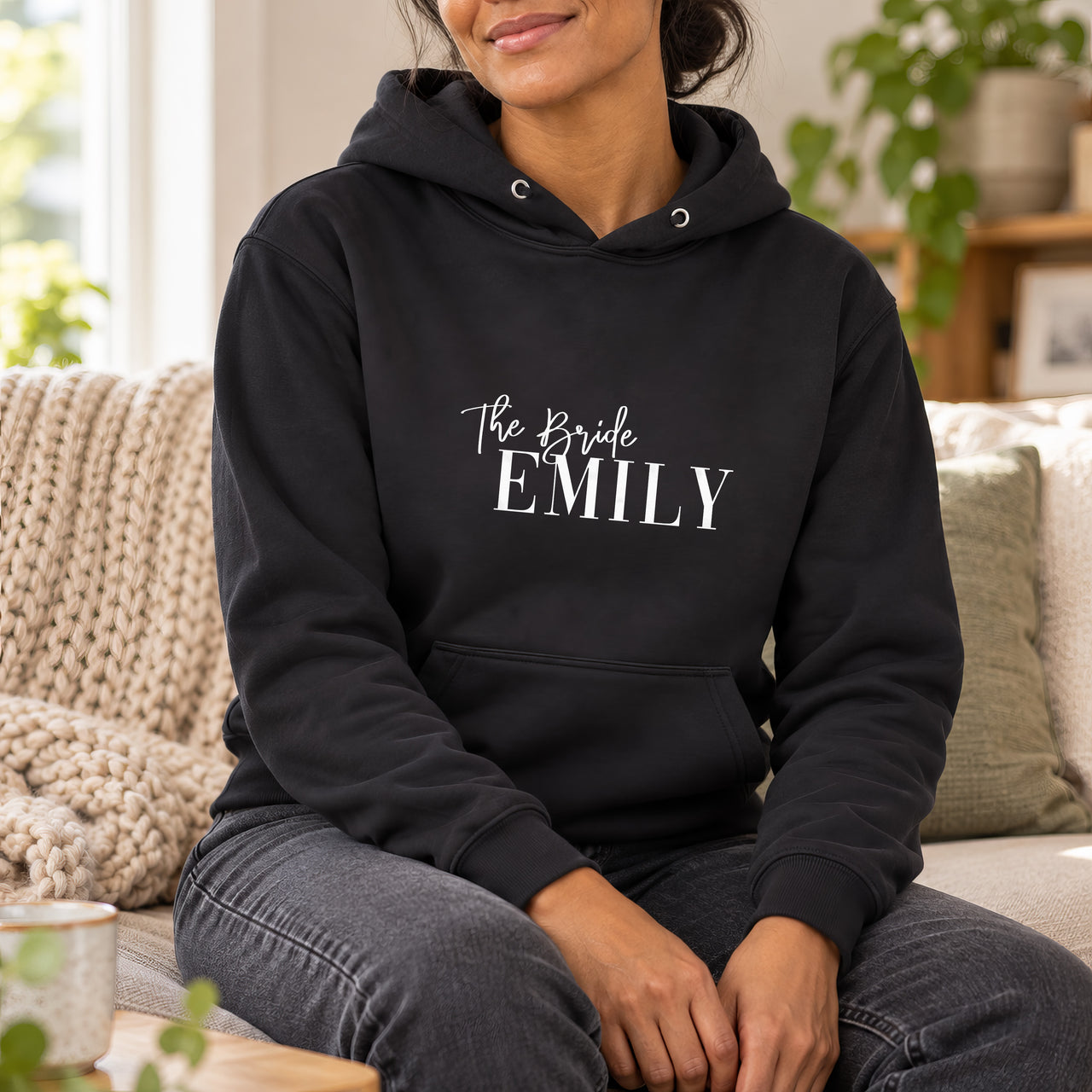 Black hoodie with the The Bride Serif Name design printed on the chest