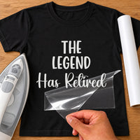 Black T-shirt with white 'THE LEGEND' capitals and 'Has Retired' script iron-on transfer, iron and white vinyl roll