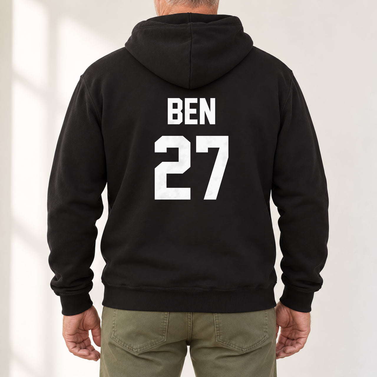 Black hoodie with the Training Kit Name and Number design printed on the back