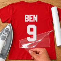 Training Kit Name Number iron-on transfer: white BEN 9 on a red T-shirt, film being peeled