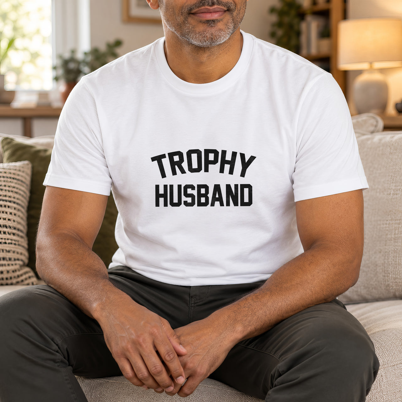 White T-shirt with the Trophy Husband design printed on the chest