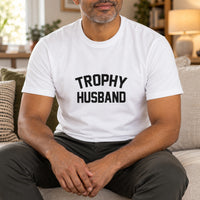 White T-shirt with the Trophy Husband design printed on the chest