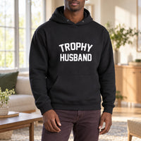 Black hoodie with the Trophy Husband design printed on the chest
